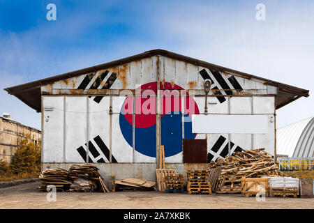 Close-up of the national flag of South Korea painted on the metal wall of a large warehouse the closed territory on a summer day. The concept of stora Stock Photo