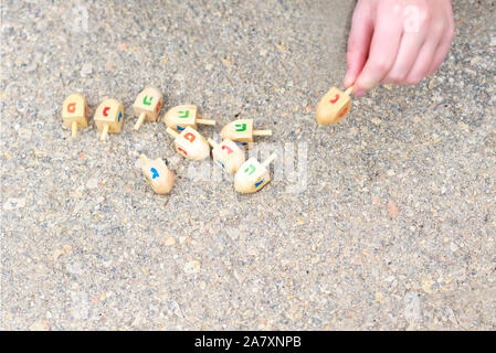 Dreidels For Hanukkah. Wooden dreidels for playing a game during the Jewish holiday of Chanukah. Stock Photo