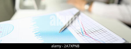 Silver pen lies on paper documents with color Stock Photo