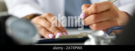 GP hands writing with silver pen document Stock Photo
