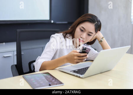 Businesswoman asian using phone for celling and texting on her mobile phone Stock Photo