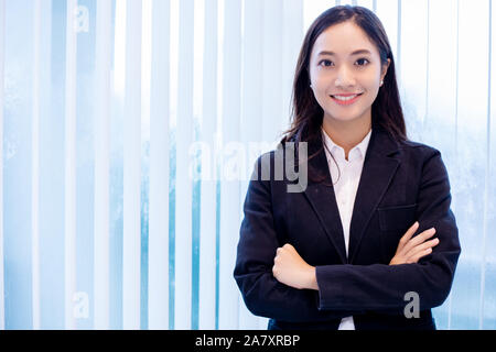 Asian business women and group using notebook for meeting and business women smiling happy for working Stock Photo