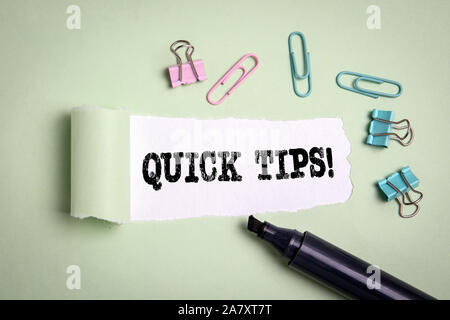 Quick Tips. Tutorial, teaching, studying and conference. Text under torn paper Stock Photo