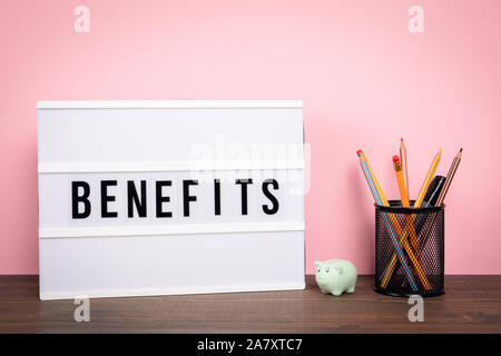 Benefits. Career, insurance, cash prize and opportunities. White lightbox on a wooden table Stock Photo