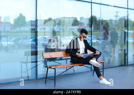 Cool guy arabic man uses laptop business center Stock Photo