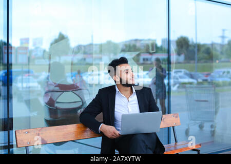 Cool guy arabic man uses laptop business center Stock Photo