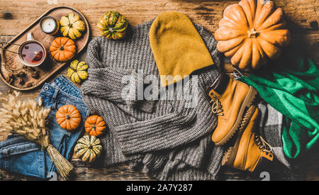Autumn trendy women outfit layout over rustic wooden background Stock Photo