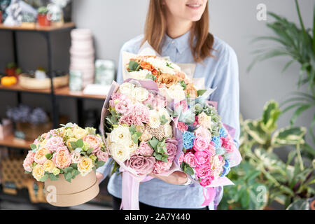 Beautiful bouquet of mixed flowers in woman hand. Floral shop concept . Handsome fresh bouquet. Flowers delivery. Red and pink color. Stock Photo
