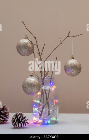 Alternative Christmas Tree concept. Christmas Tree made from branches and decorated with golden balls Stock Photo