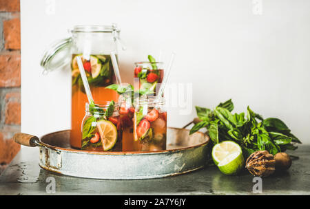 Fresh strawberry and basil lemonade in glass jars, copy space Stock Photo