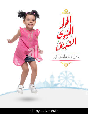 Happy Active Young Girl Jumping in The Air with Kids Amusement Park in Background, Text Translation: Happy Holiday of Holy Prophet Muhammad's Birthday Stock Photo