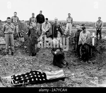 Marine colonel Francis Fenton kneels and prays at the foot of his sons flag draped body , PFC Michael Fenton who was killed in a counter attack on the road to Shuri, Okinawa Stock Photo