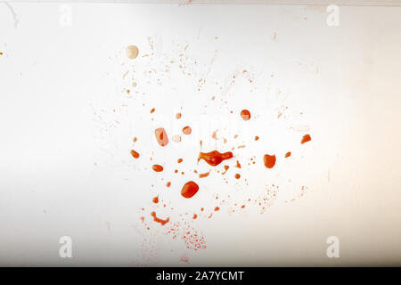 Glossy red liquid droplets, splatters isolated. drops of red juice on a white dirty background Stock Photo