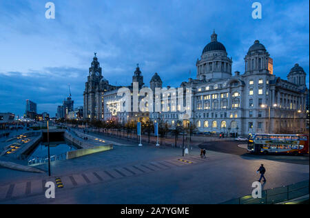 The Three Graces buildings, Royal Liver Building, Cunard Building and Port of Liverpool Building, seen at night at Pier Head in Liverpool Stock Photo