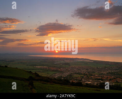 Sunset and North Wales coast seen from Offa's Dyke long distance footpath, above Prestatyn, Denbighshire. Stock Photo