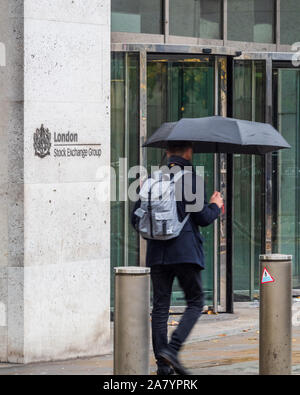 London Stock Exchange - a City worker passes the London Stock Exchange building at 10 Paternoster Row in the City of London Financial District Stock Photo