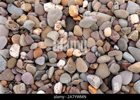 Smooth stones texture background. Rounded stones on Atlantic ocean coast. Stock Photo