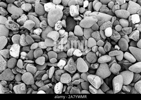 Smooth stones texture background. Rounded stones on Atlantic ocean coast. Stock Photo