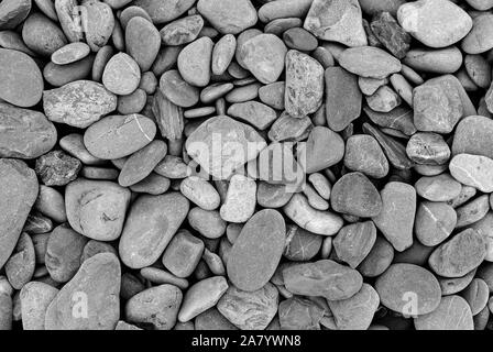 Smooth stones texture background. Rounded stones on Atlantic ocean coast. Stock Photo
