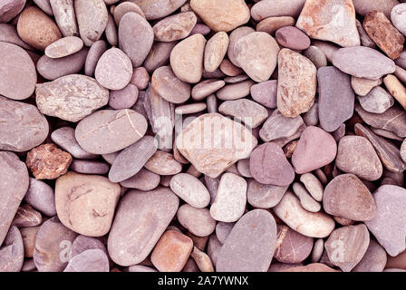 Smooth stones texture background. Rounded stones on Atlantic ocean coast. Stock Photo