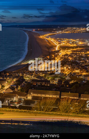 Portland Dorset England Night time view over the town of Fortuneswell, and Chesil Beach, seen from Portland Heights Stock Photo