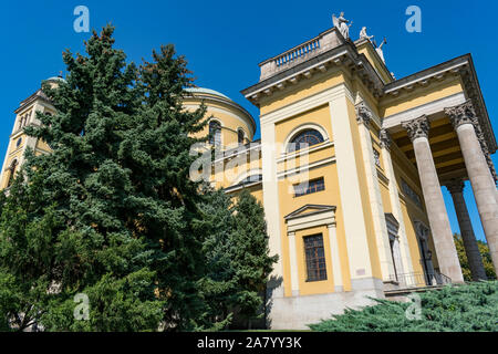 Side view of Cathedral Basilica of St. John the Apostle or Basilica of Eger with tall tree, blue sky and no people. Stock Photo