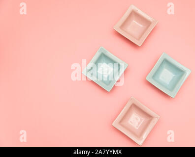 Four small decorative tabletop bowls pink and light blue on a pink backround Stock Photo