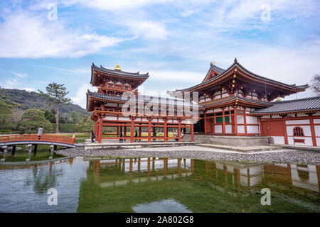 Uji, Japan - March. 23, 2019: Beautiful Byodoin temple in spring with lake water reflection, springtime travel image in Uji, Kyoto, Japan. Stock Photo