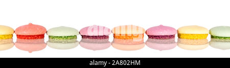 Header, colorful various cookies or macarons in a line, cutout on white background Stock Photo