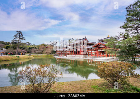 Uji, Japan - March. 23, 2019: Beautiful Byodoin temple in spring with lake water reflection, springtime travel image in Uji, Kyoto, Japan. Stock Photo