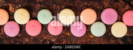 Panorama, Macarons, biscuits or cookies in a line on a rusty background, topview Stock Photo