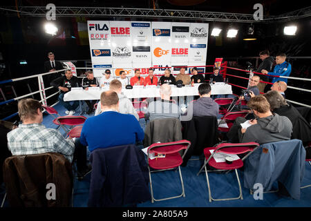 05 November 2019, Hamburg: At the side of Ismail Özen-Otto (5.f.l), Promoter Universum Box Promotion, Flavio Oleaga Mirabal (l-r), Matchmaker, Andreas Schenkat, Universum, Toni Kraft, Boxer, Artem Harutyunyan, Boxer, Artur Grigoryan, Trainer, Ali Ertan Toprak, Press Officer, Bernd Bauer, his son Leon Bauer, Boxer, and Frederik Ness, Team Sauerland, sit on the podium at a press conference in the Box-Gym Universum. On 09.11.2019 there will be a fight evening in Hamburg for the IBO International title in super light weight between Harutyunyan from Germany and Dumanov from Russia. Photo: Christian Stock Photo