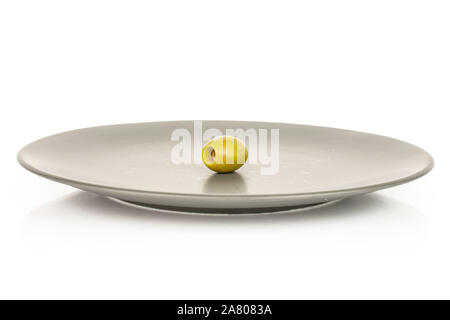 One whole pitted green olive on gray ceramic plate isolated on white background Stock Photo