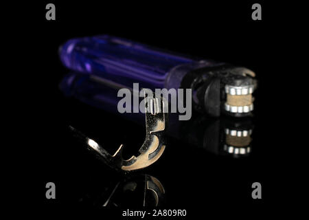 Group of one whole one piece of plastic lighter isolated on black glass Stock Photo