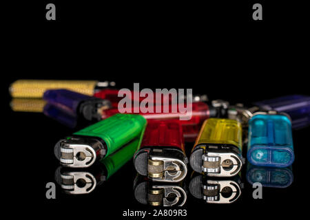 Lot of whole plastic lighter isolated on black glass Stock Photo