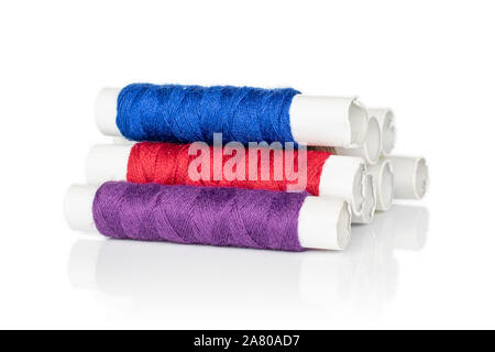 Group of eight whole sewing thread spool heap isolated on white background Stock Photo