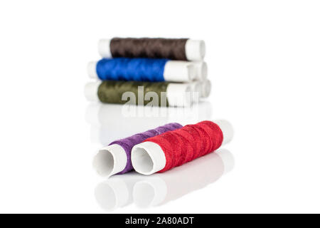 Group of eight whole sewing thread spool two in focus isolated on white background Stock Photo
