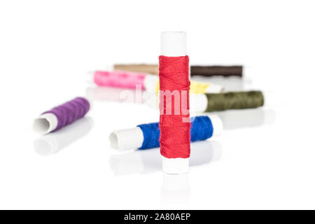 Group of eight whole sewing thread spool isolated on white background Stock Photo