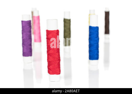 Group of eight whole sewing thread spool isolated on white background Stock Photo