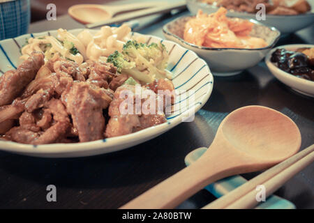 Chinese style pork dish on table with side dishes Stock Photo