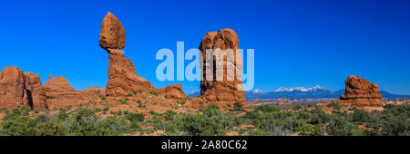 Balanced Rock Desert Panorama in Arches National Park with the La Sal Mountains in the background Stock Photo