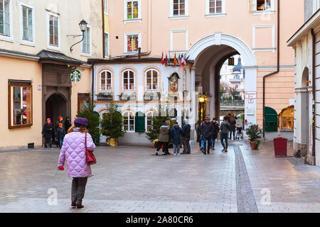 Salzburg, Austria - December 25, 2016: Christmas trees and historical center street with people Stock Photo