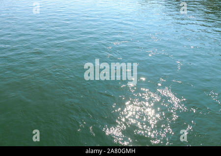 Background texture of sparkling rippling water in a river with reflections of the sunlight causing specular highlights Stock Photo