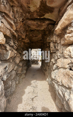 Tunnel between the walls of the ruins of Tulum Stock Photo