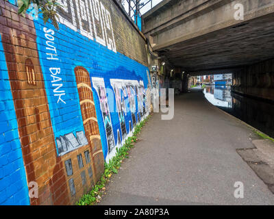 Leeds and Liverpool Canal passes under the railway on the way into Granary Wharf at Leeds West Yorkshire England Stock Photo