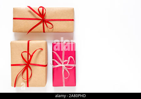Small boxes with gifts, ribbons and bows on a white background. Copy space Stock Photo