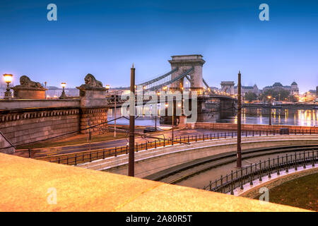 Chain bridge early in the morning. Empty streets, misty fall mweather, tram rails, sidewalk Stock Photo