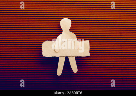 Paper man shape holding burnt note paper in hand Stock Photo