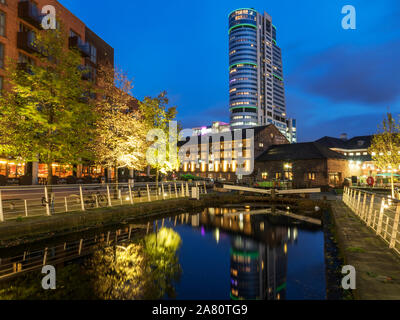Bridgwater Place reflected in the Canal Basin at Granry Wharf at dusk Leeds West Yorkshire England