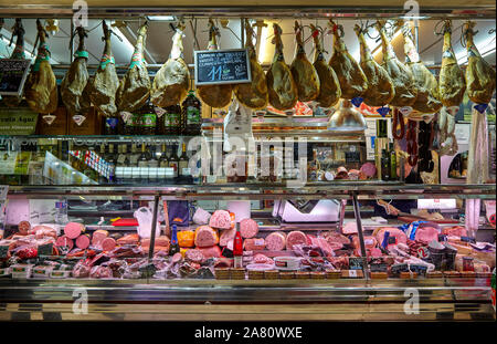 Fully stocked butcher shop at Mercat de Russafa, Russafa indoor food market, Valencia, Spain. Stock Photo